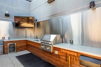 A modern kitchen with stainless steel appliances and wooden accents.